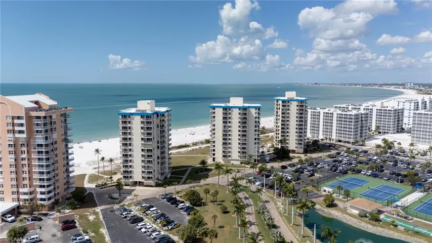 Drone / aerial view of apartment complex / building and unending shoreline