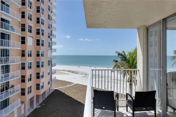 Balcony with view of water and beach