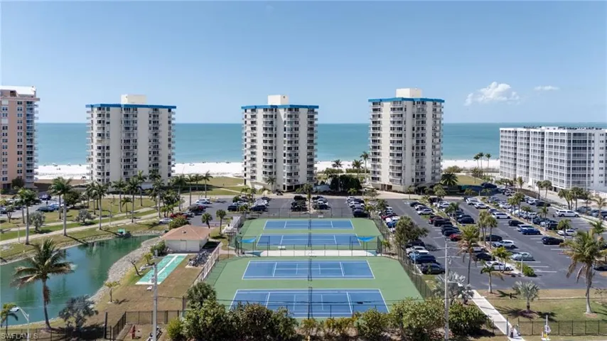 Aerial view of a large body of water and apartment complex / building