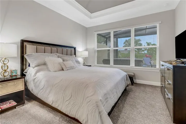 Bedroom with light carpet and ornamental molding