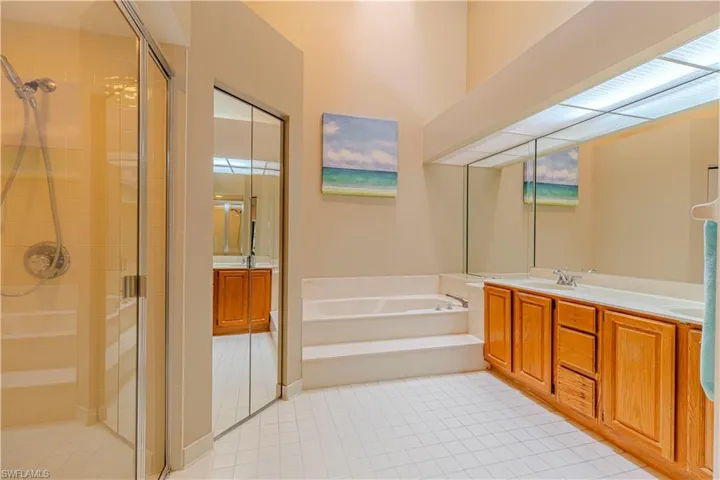 Bathroom with tile patterned floors, vanity, and independent shower and bath