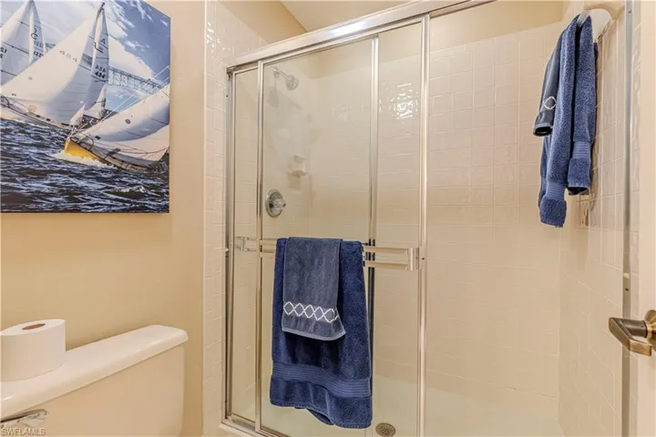 Second bathroom with toilet and a shower with door