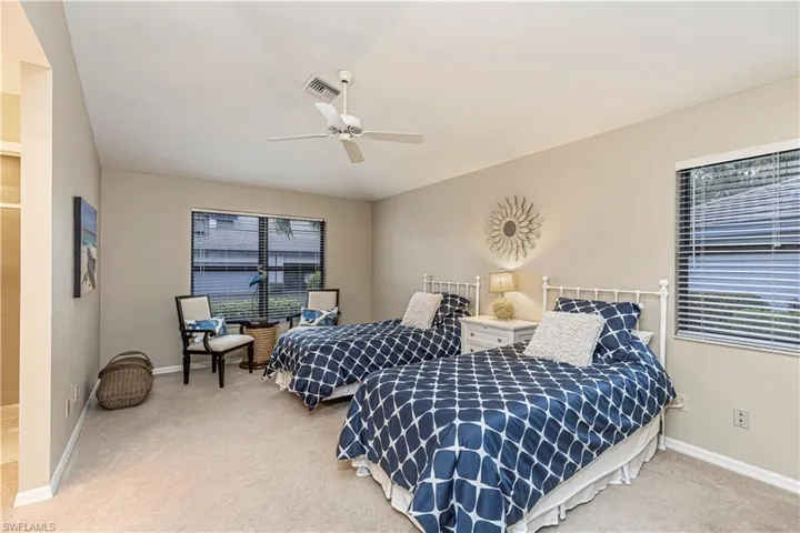 Second bedroom featuring carpet flooring and ceiling fan