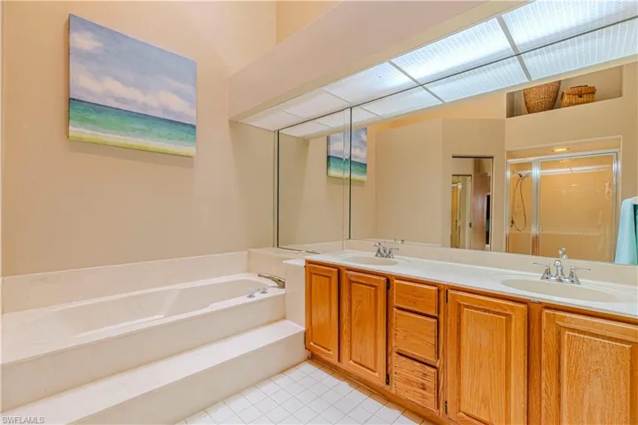 Bathroom with tile patterned floors, vanity, and independent shower and bath