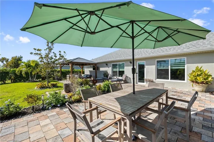 View of patio with a gazebo and outdoor dining area