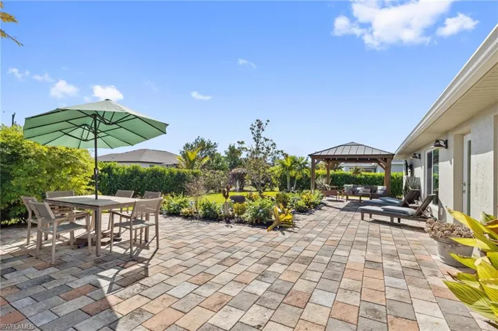 View of patio featuring outdoor dining area, a gazebo, and outdoor lounge area