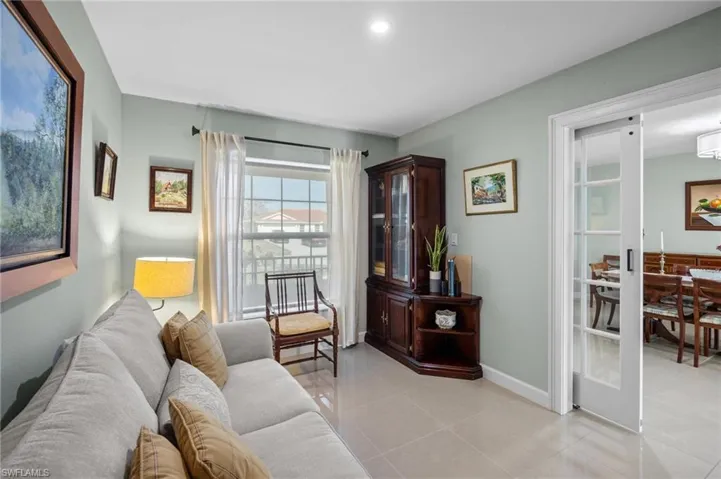 Living room featuring light tile patterned floors and baseboards