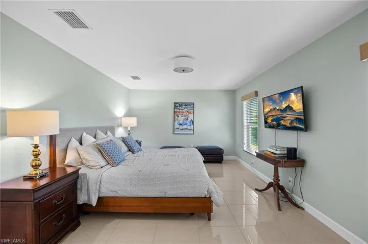Bedroom featuring light tile patterned flooring and baseboards