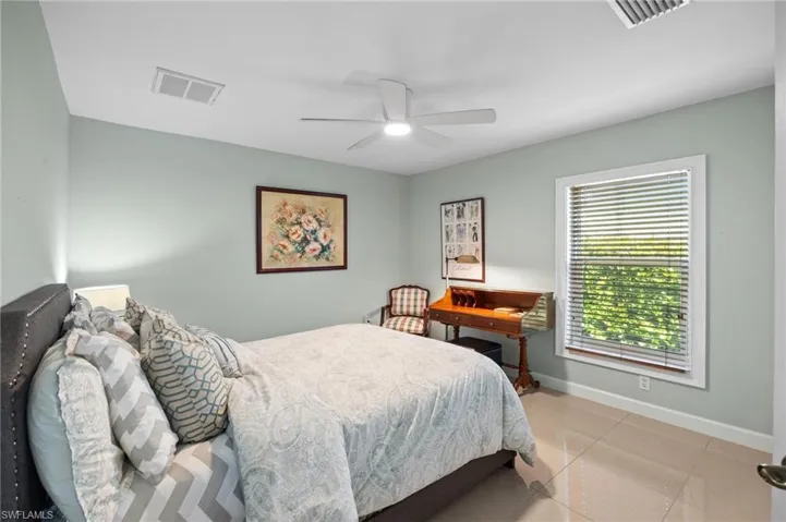 Bedroom featuring light tile patterned floors and a ceiling fan