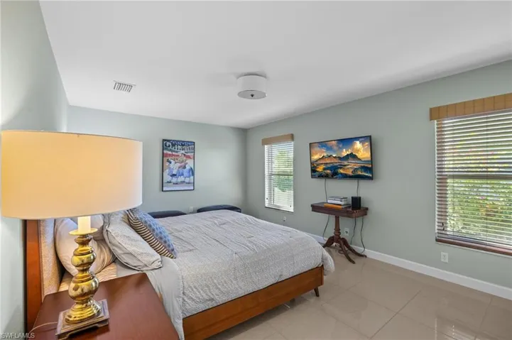 Bedroom with tile patterned floors and baseboards