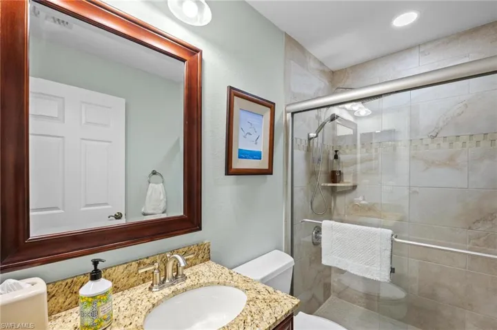Full bath featuring vanity and a shower stall