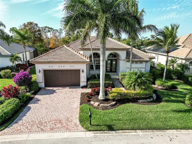 Beautiful landscape with a Royal Palm and rock garden border details