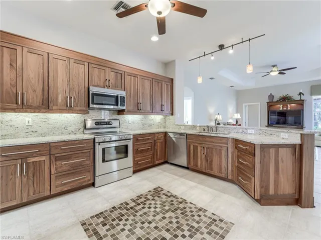Updated cabinetry, with granite counter and backsplash