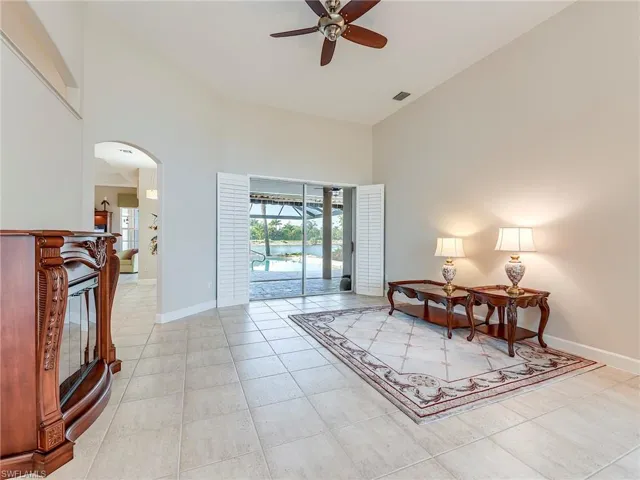 Formal living room upon entry with a pool view