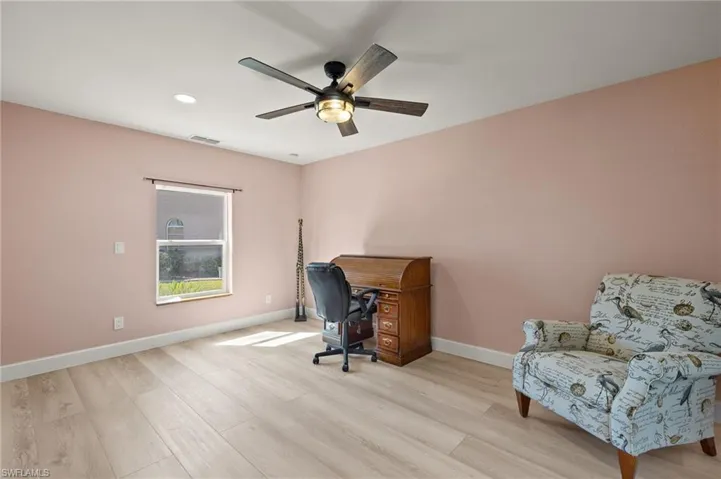 Guest Bedroom with ceiling fan, baseboards, and light wood-type flooring