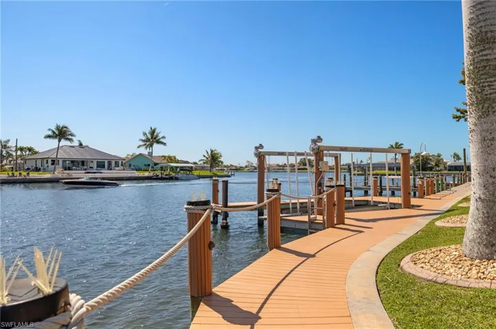 Dock area featuring a residential view, a water view, and boat lift