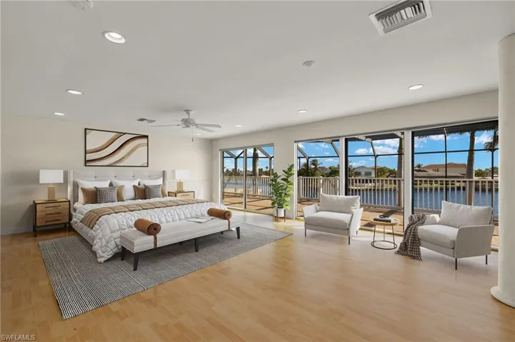 Bedroom with wood finished floors, visible vents, access to outside, and recessed lighting