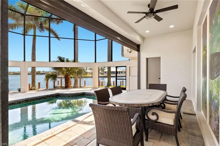 Sunroom featuring a water view