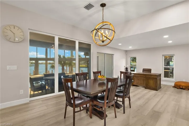 Dining space featuring light wood-type flooring, an inviting chandelier, baseboards, visible vents, and recessed lighting