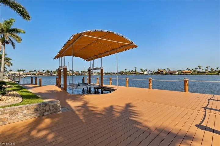 View of dock with a water view and boat lift