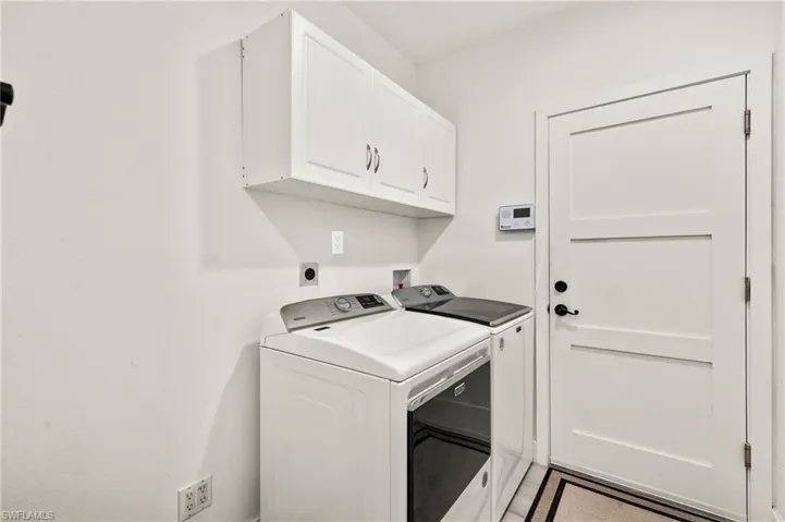Clothes washing area with washing machine and dryer and cabinet space