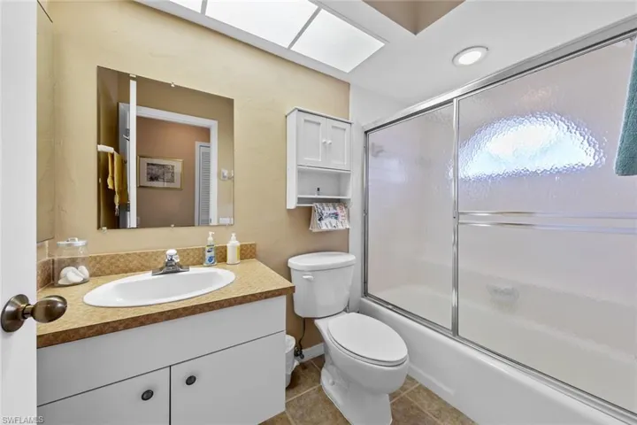 upstairs bathroom toilet, bath / shower combo with glass door, and vanity