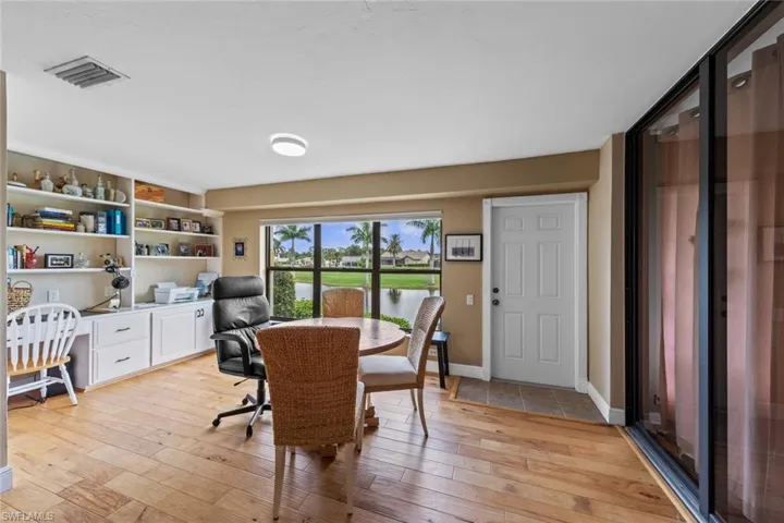 Office space featuring built in desk and light hardwood / wood-style flooring