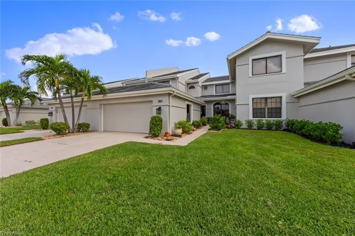 View of front of house with a front yard and a garage
