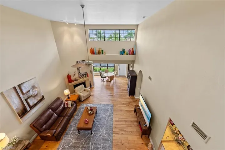 Living room featuring wood-type flooring and a high ceiling