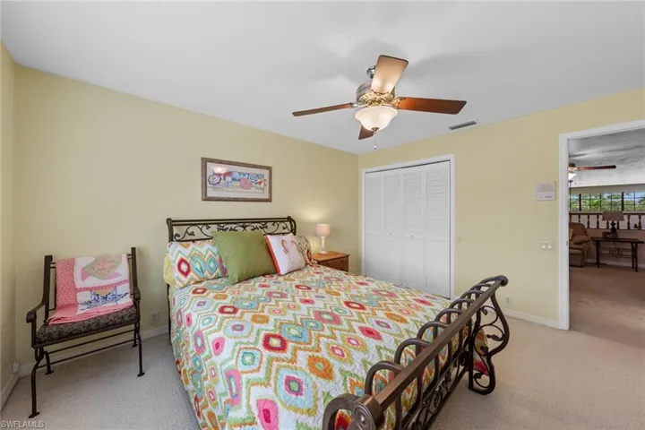 Upstairs Bedroom featuring light colored carpet, ceiling fan, and a closet