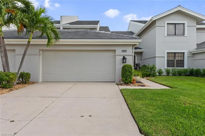 View of front of property with a garage and a front yard