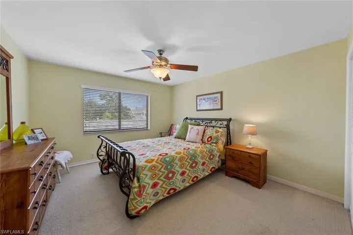 Bedroom featuring ceiling fan and light colored carpet