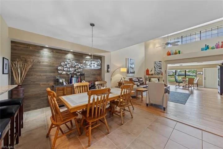 Dining room with wood walls, hardwood / wood-style floors, and a chandelier