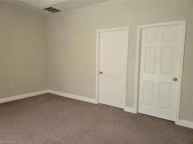 Unfurnished bedroom featuring carpet floors and baseboards