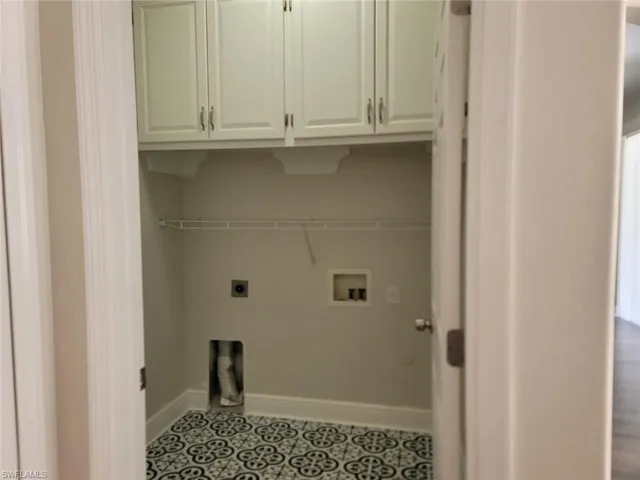 Laundry area with hookup for a washing machine, electric dryer hookup, and cabinet space