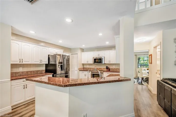 All white kitchen with granite and stainless appliances