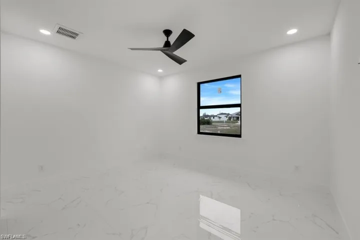 Empty room with marble finish flooring, recessed lighting, and ceiling fan