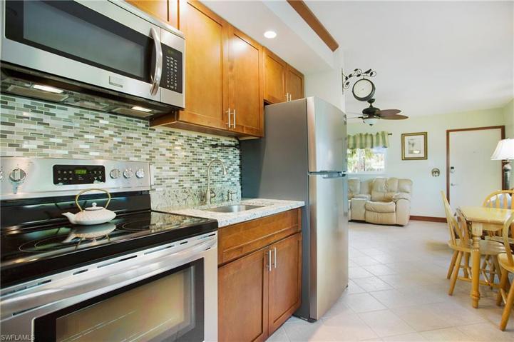 The Kitchen is equipped with NEW stainless appliances, granite surfaces, mosaic tile backsplash and recessed lighting!