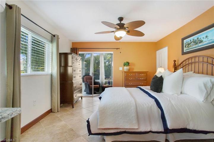 The large Bedroom with tile flooring, tons of natural light and access to the Enclosed Lanai.