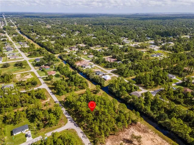 View of property location featuring nearby suburban area and a nearby body of water