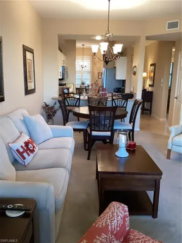Living room featuring carpet floors and a chandelier