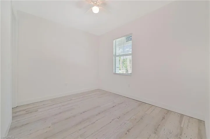 Empty room with light wood-type flooring and ceiling fan