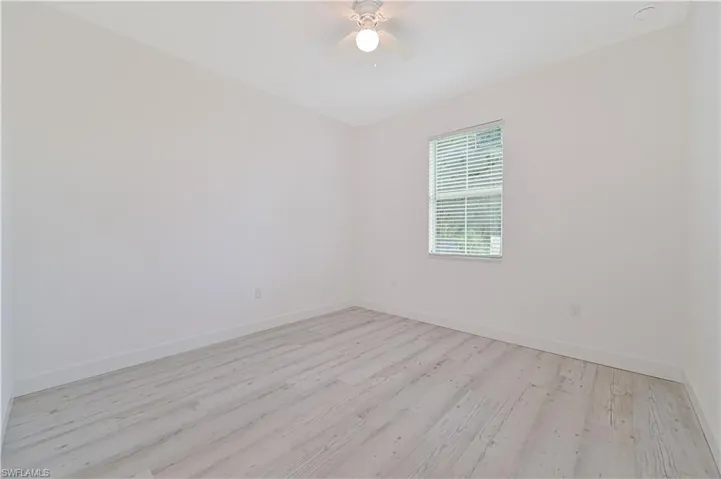 Spare room featuring ceiling fan and light hardwood / wood-style flooring