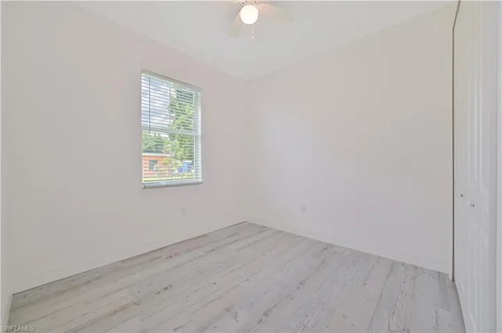 Unfurnished room featuring light wood-type flooring and ceiling fan