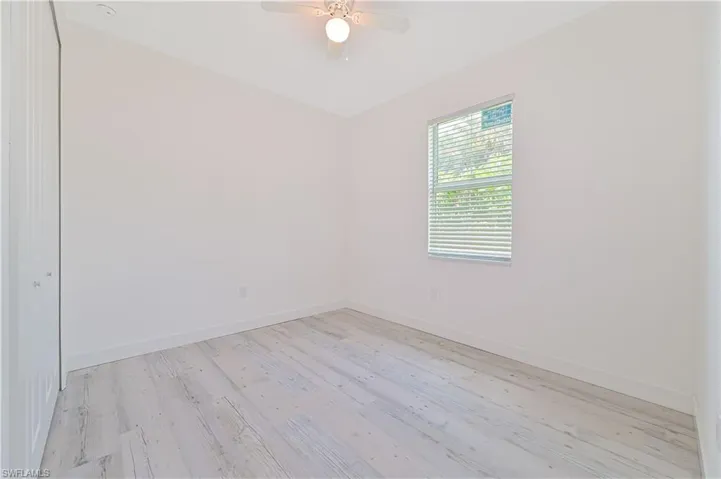 Spare room featuring light hardwood / wood-style floors and ceiling fan
