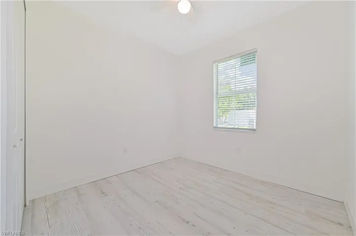 Spare room featuring ceiling fan and light hardwood / wood-style flooring