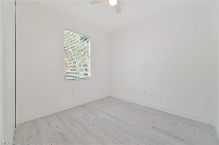 Spare room with light hardwood / wood-style floors and ceiling fan