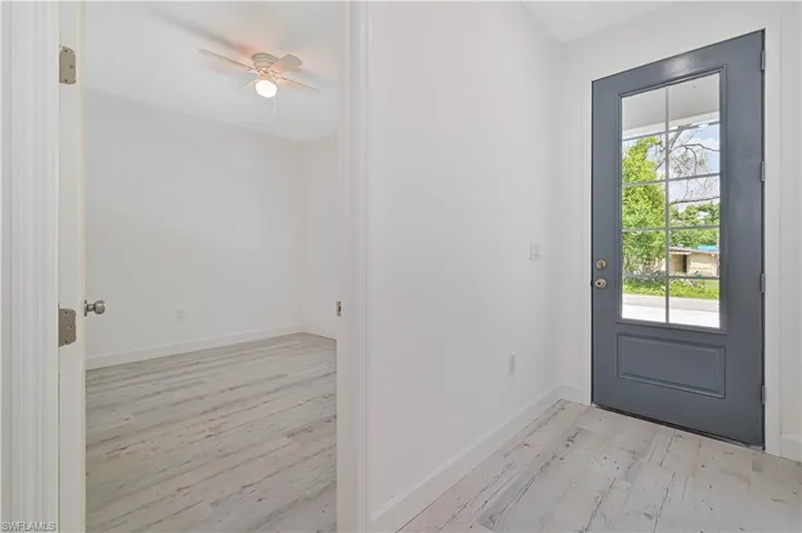 Foyer entrance featuring ceiling fan and light hardwood / wood-style flooring