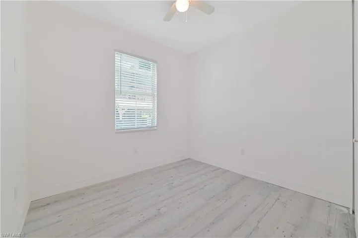 Spare room featuring ceiling fan and light hardwood / wood-style flooring