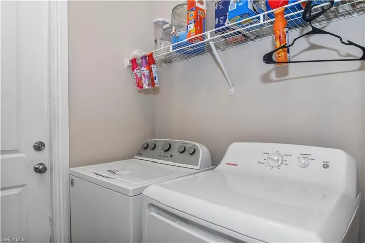 Laundry room featuring washer and clothes dryer and laundry area